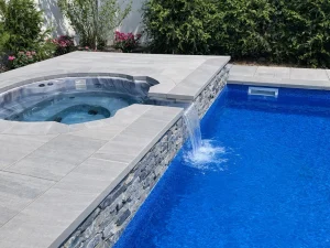 spillover hot tub with stone wall