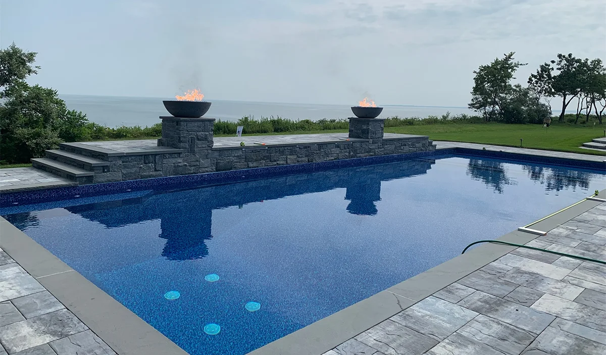 Geometric Pool with Raised Wall and Fire Bowls