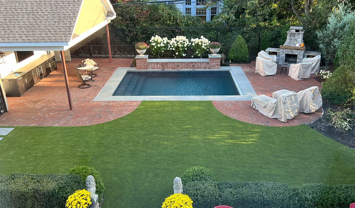 Geometric Pool with Brick Patio and Outdoor Living Area